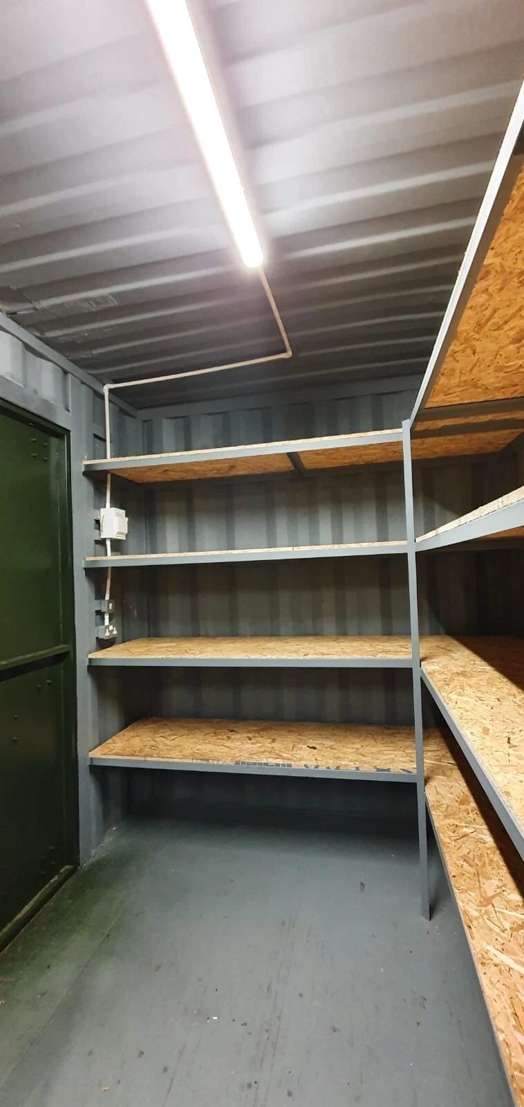 20ft High Cube Storage Container – Lighting and Shelving – Container interior with wooden shelving and overhead strip lighting