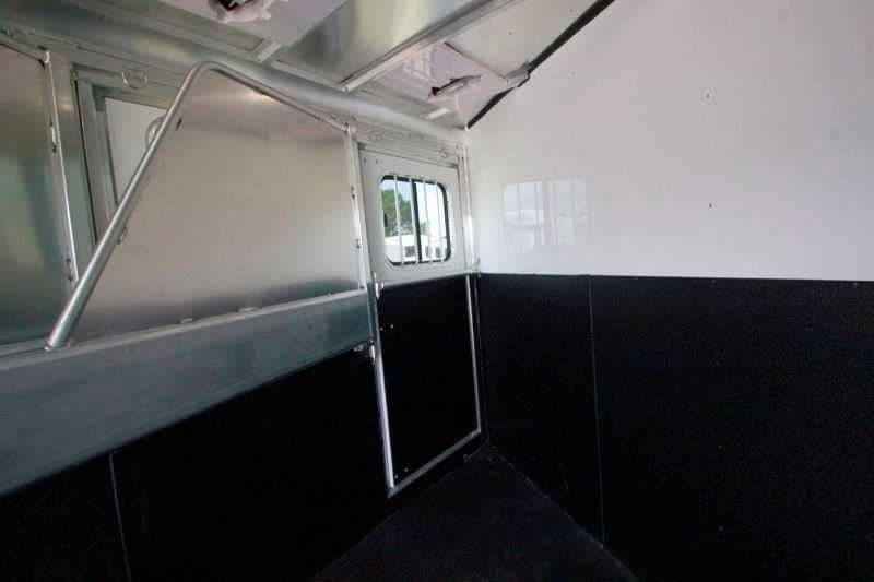 2016 Sundowner 3 Horse Gooseneck – Aluminum, Dressing Room – Looking into the horse area from the rear showing the side escape door