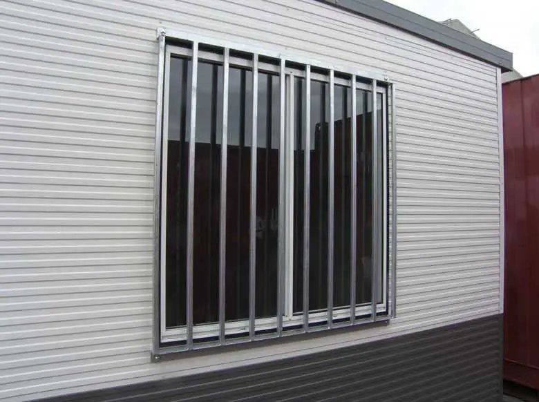 20 ft Container Change Room – Gray – Close up view of an external sliding window with security bars on a cabin