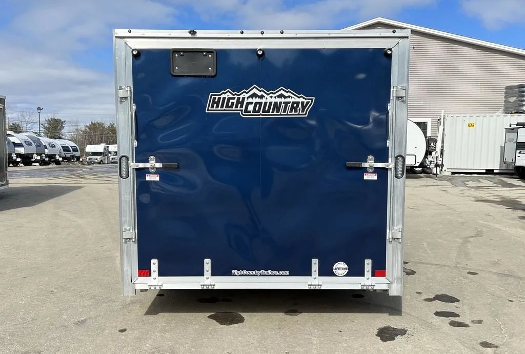 2023 High Country 14 ft Trailer – Blue, Drive-Through – Direct rear view of the closed blue ramp door with manufacturer decals