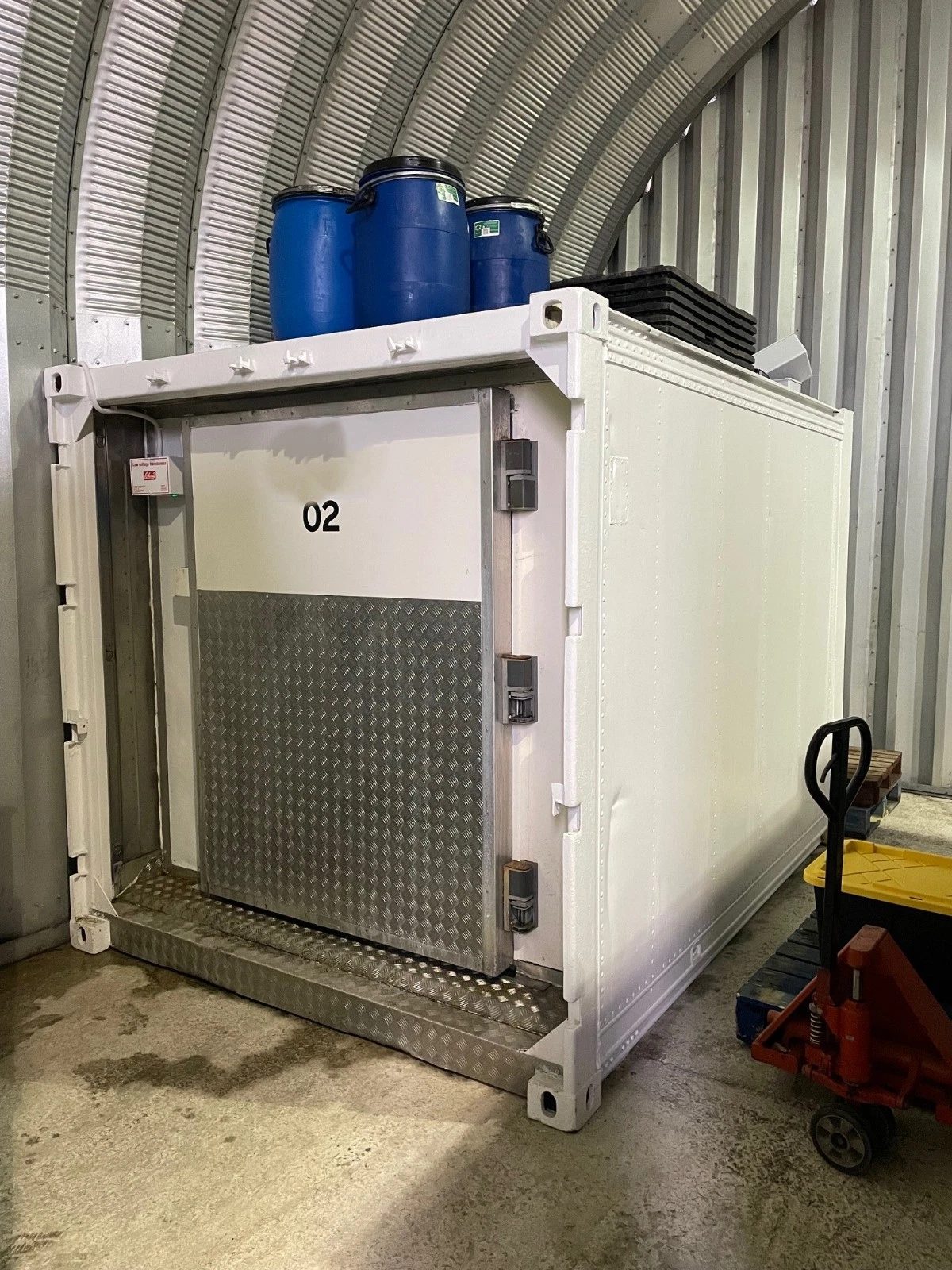10ft Refrigerated Shipping Container – Fridge and Freezer – three-quarter view of white refrigerated container inside storage shed