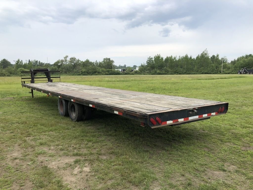 2002 Kaufman 40 ft Equipment Trailer – Toolbox – Rear three-quarter view of the wooden deck and black metal frame
