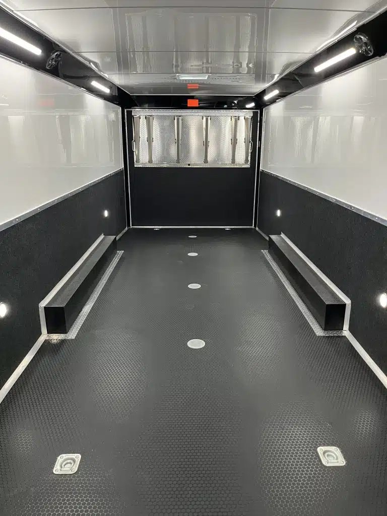 2025 Haulmark Edge 28 ft Car Trailer – Blackout, Turbo – Interior view from rear looking towards front with black coin flooring and white walls