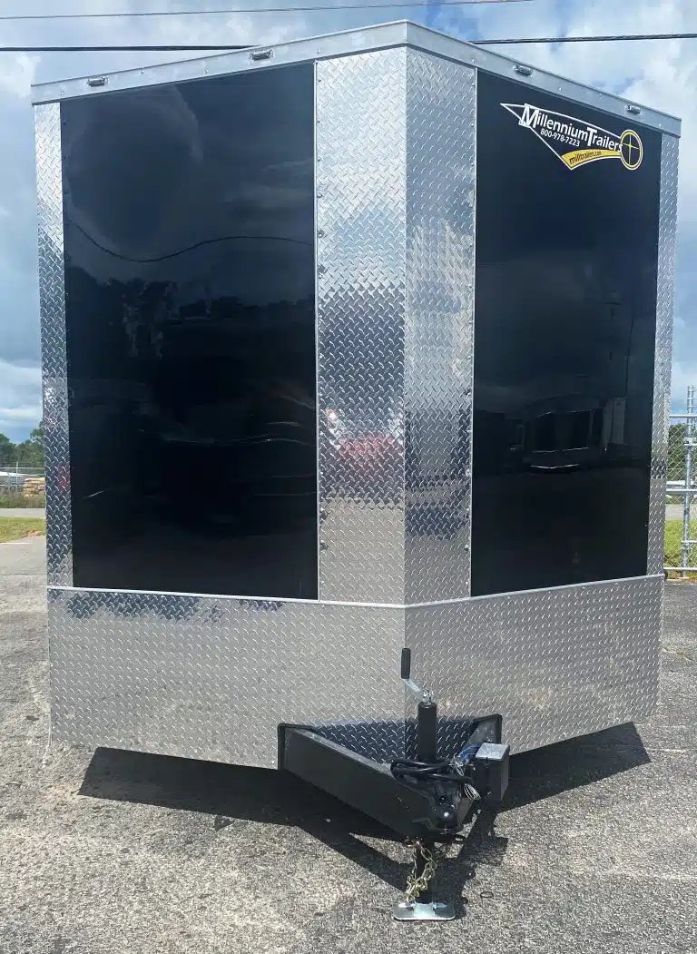 2026 Millennium 20 ft Car Trailer – Extra Height – Front view of black enclosed trailer showing V-nose and diamond plate stone guard
