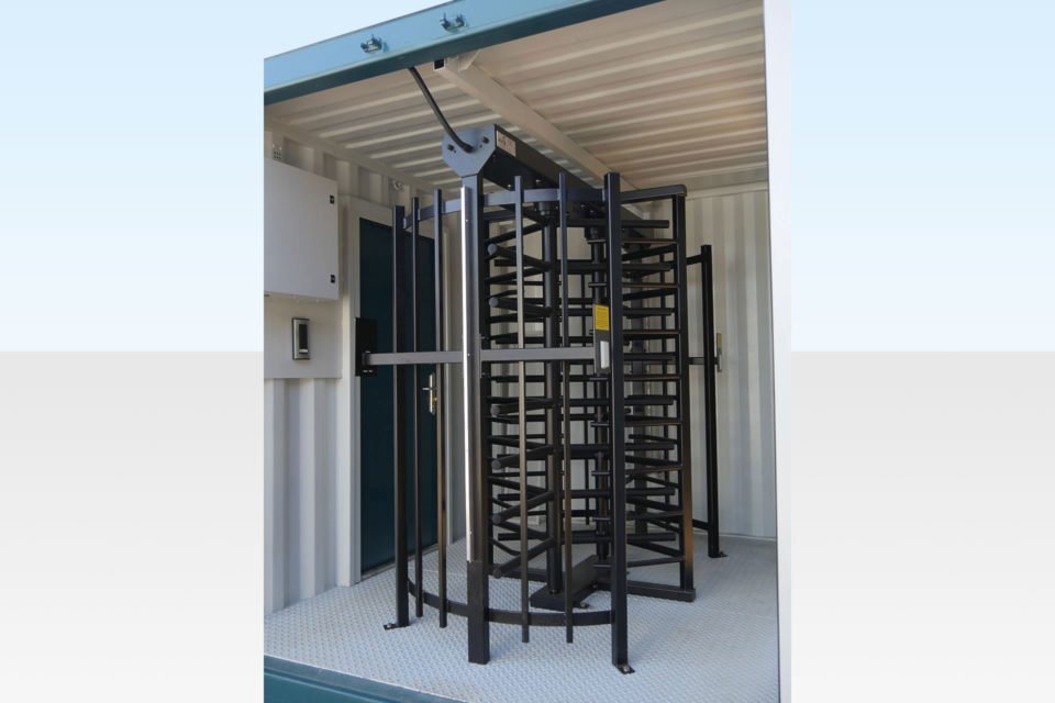 Steel Double Turnstile Unit – Blue, Separate Entry And Exit – Close-up view of a black metal double turnstile installed inside the container unit