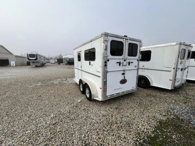 2019 Sundowner Charter 2 Horse Trailer – Warmblood Size – Rear three-quarter view of the trailer from the opposite side on gravel