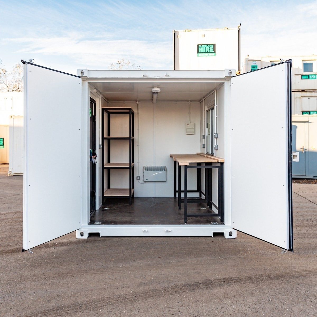 10ft Custom Workshop Shipping Container – Unfitted Steel Shell – Open container doors revealing workshop shelving and wooden workbench