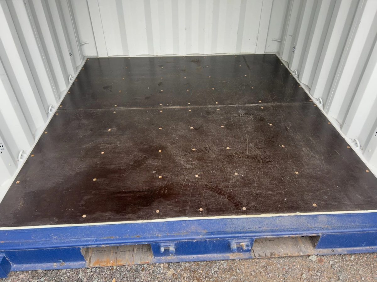 10ft New Shipping Container – Double Cargo Doors – Empty container interior with dark plywood floor and white walls