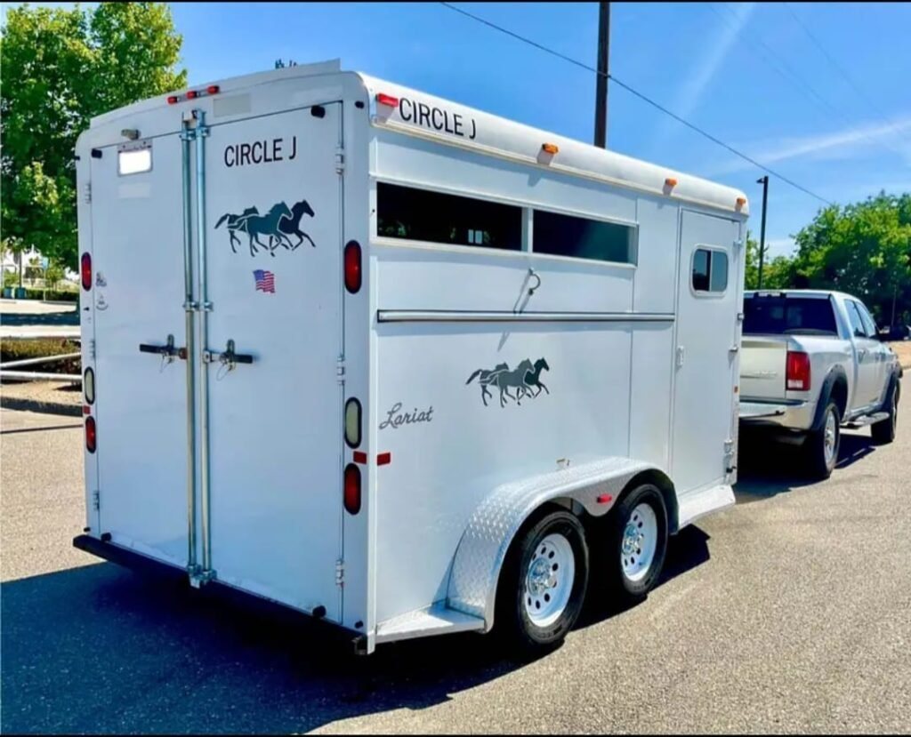 2007 Circle J 2 Horse Trailer – Slant Load – Rear and left side of white horse trailer with dual axles