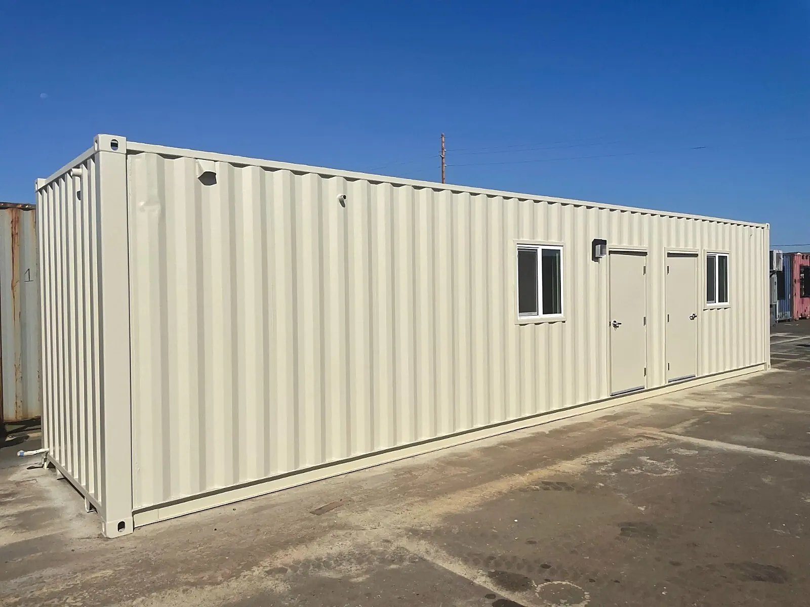 40ft Converted Container Office – Accessible Restroom – three-quarter exterior of container office with two doors and windows