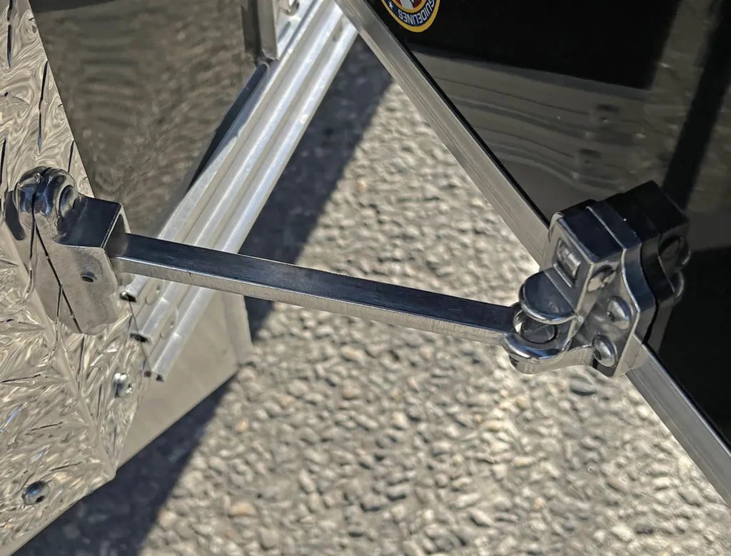 2024 Sno Pro 22 ft Snowmobile Trailer – Extra Height – Metal door holder arm securing an open door against the trailer body