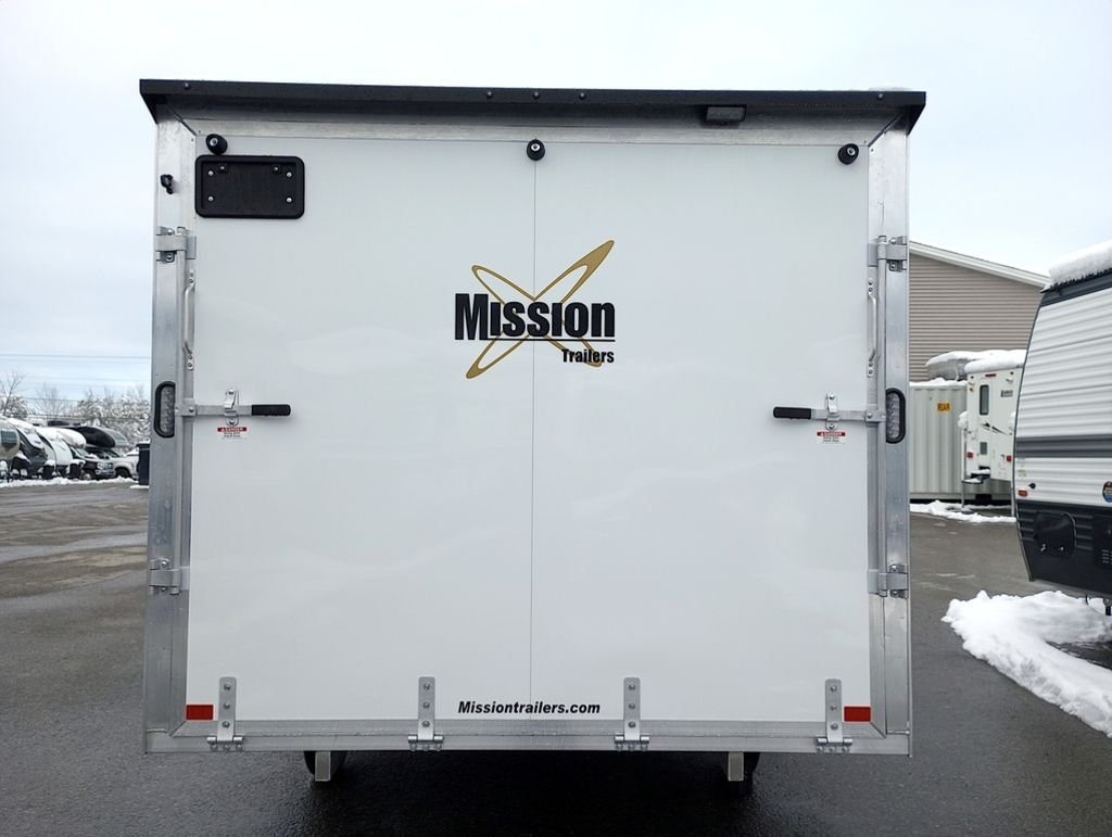 2024 Mission Trailers 12 ft Powersports – Side X Side – Direct rear view of the closed white trailer showing manufacturer branding and rear door handles