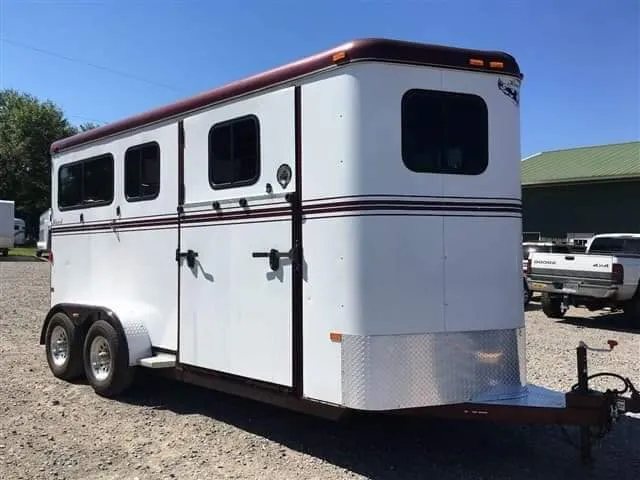 2007 Hawk 2 Horse Bumper Pull Trailer – Side Ramp – A sharp three-quarter front view of the horse trailer against a blue sky