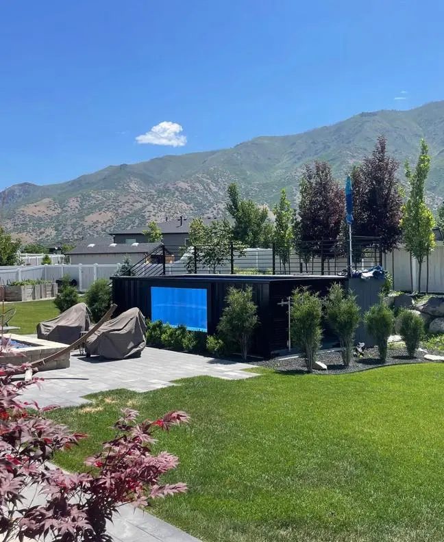 40ft Custom Container Pool – Side Viewing Window – black container pool with viewing window in landscaped backyard