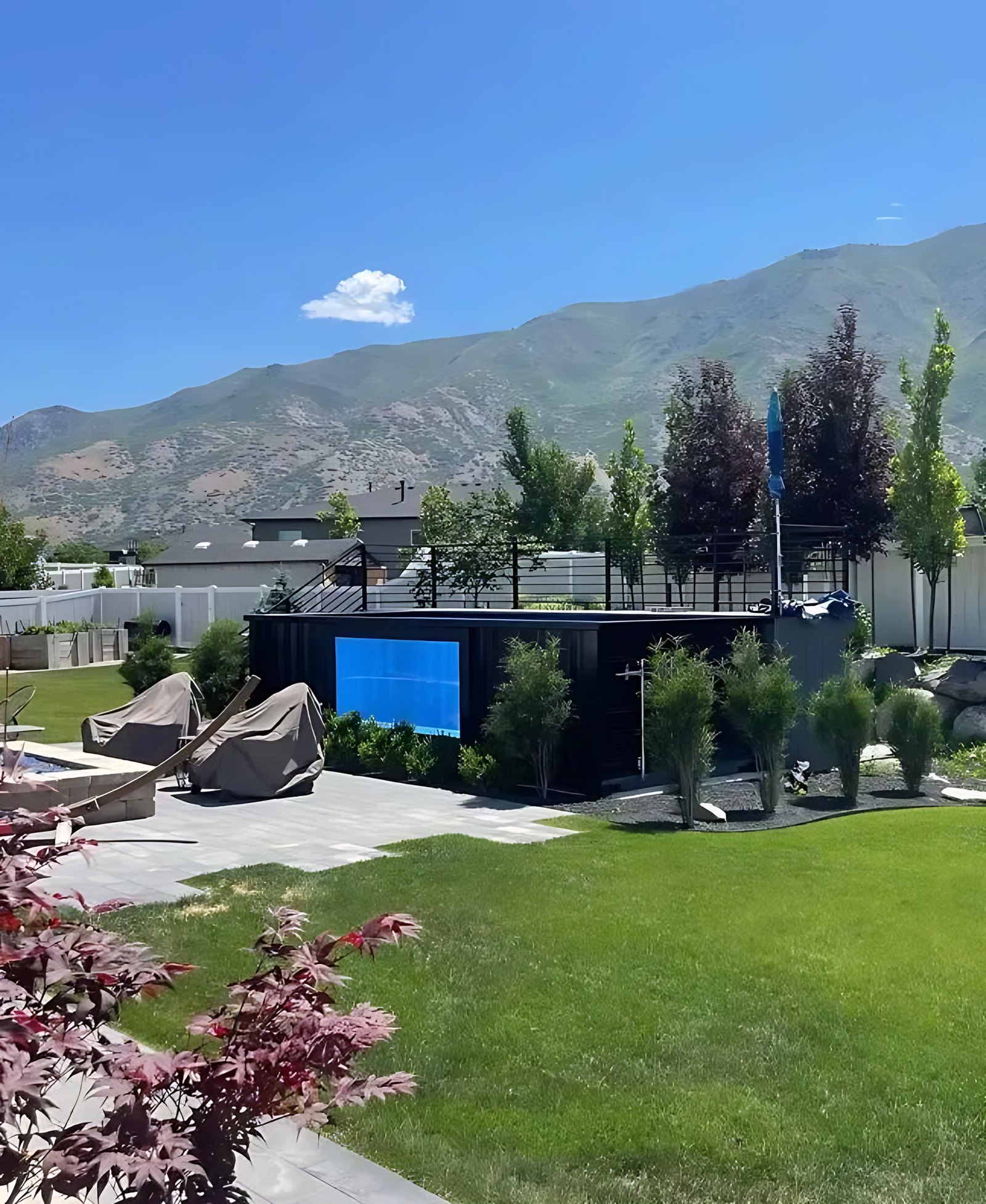 40ft Custom Container Pool – Side Viewing Window – black container pool with viewing window in landscaped backyard