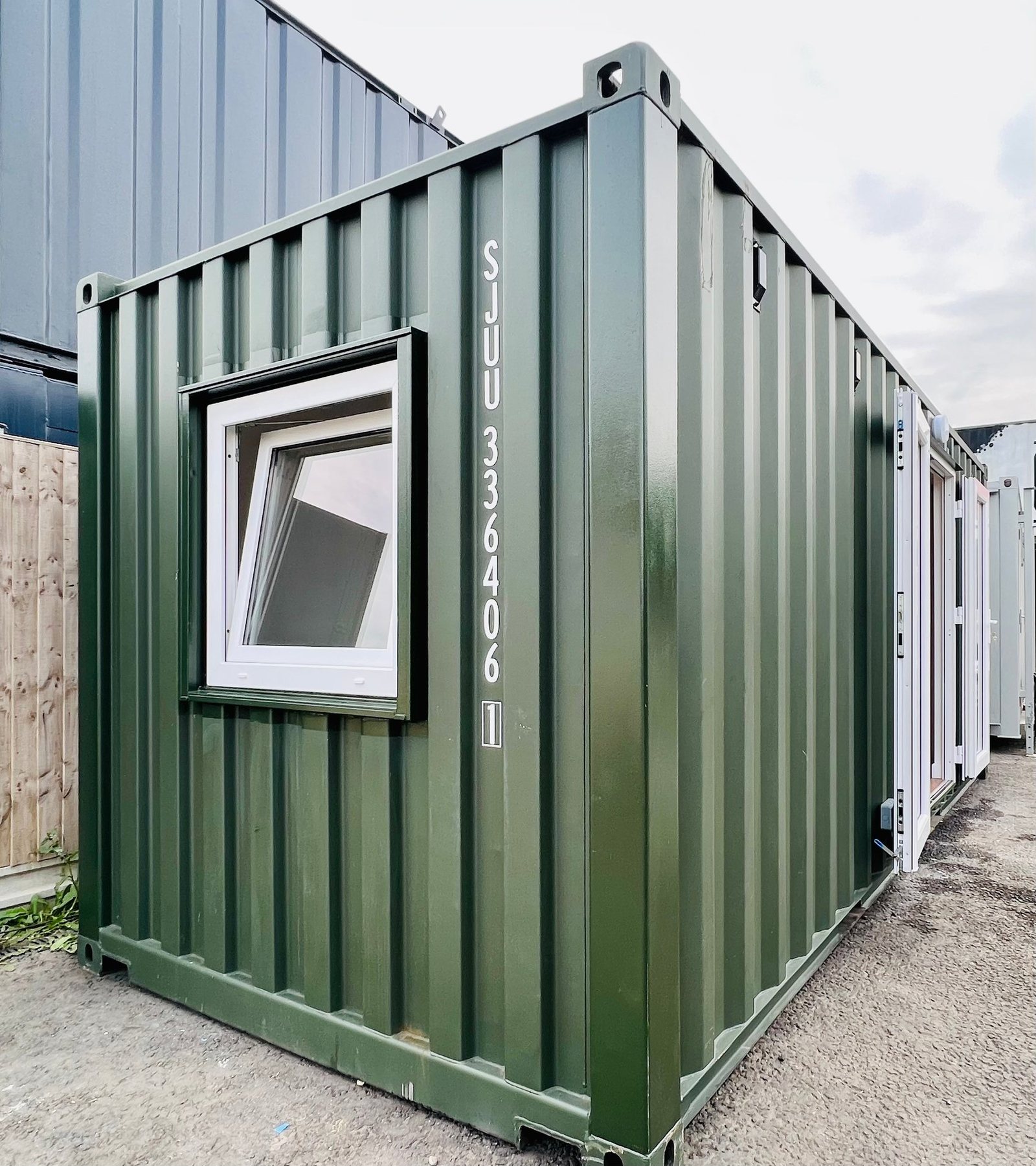 20ft Container Home – One Bed Box, 1 Bedroom – A forest green refurbished shipping container converted into a functional one-bedroom tiny house or guest annex
