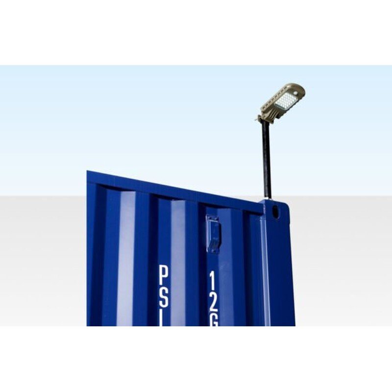 Container Solar Floodlight – Motion Sensor, 960 Lumens – Solar floodlight mounted on the corner of a blue shipping container unit