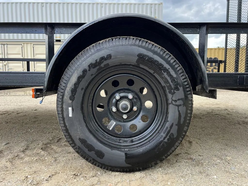 2024 Carry-On 12 ft Utility Trailer – Rear Ramp Gate – Close-up view of the black steel wheel and trailer tire under a fender