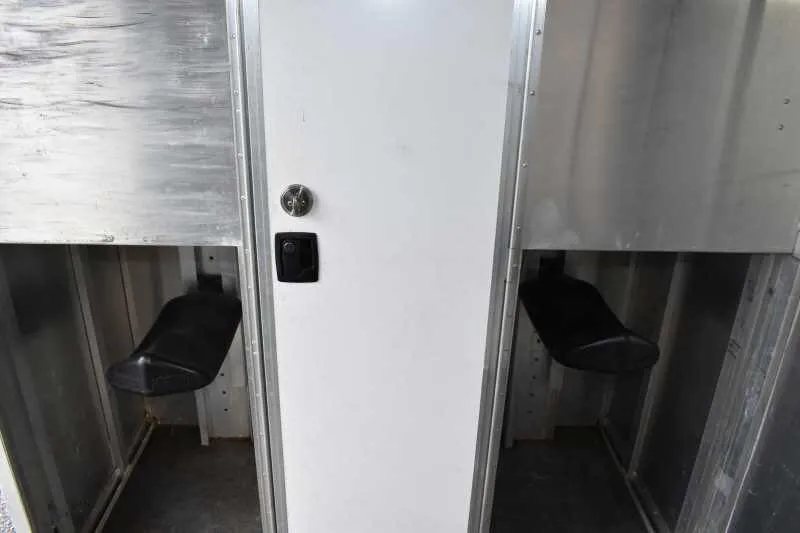 2003 Featherlite 2HST 2 Horse Trailer – Aluminum – Interior view of the tack room showing saddle racks and white walls