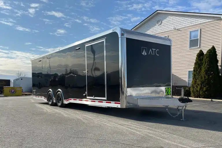 2026 ATC 28 ft Car Trailer – Premier Package – Opposite front three-quarter view of black enclosed trailer with side door