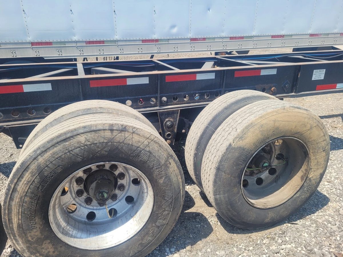 53ft Used Container Chassis – 2011, Spring Suspension – close-up of chassis frame and worn tandem tires