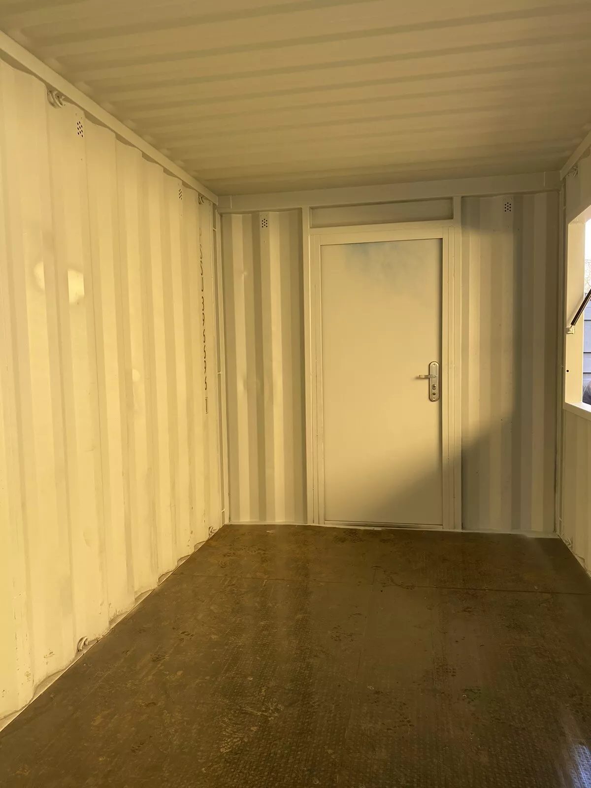 15ft Custom Container Bar & Kiosk – Side Service Hatches – empty container interior with personnel door and service hatch