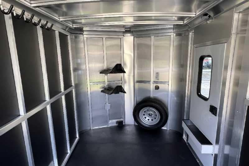2024 Shadow 2 Horse Bumper Pull Trailer – Aluminum, Dressing Room – Interior of the front tack room showing saddle racks and spare tire