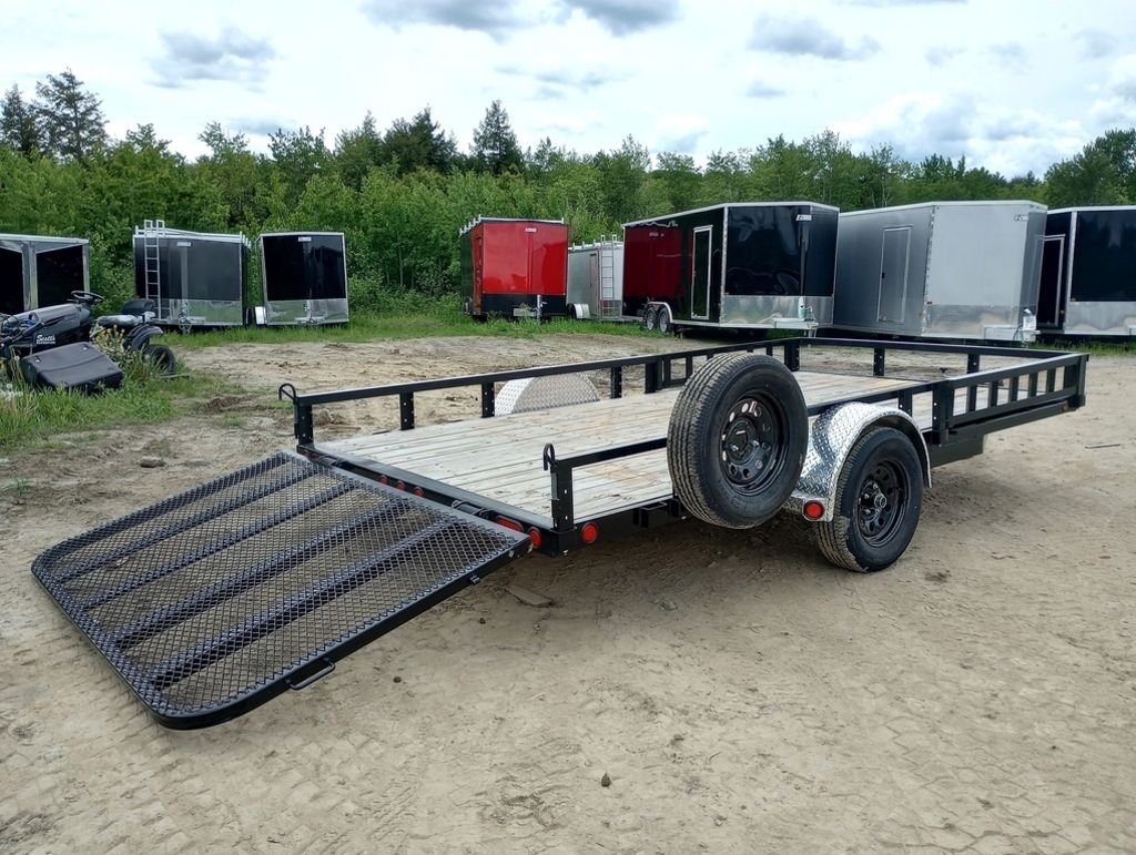 2024 PJ Trailers 14 ft Utility – Side Loading Ramps – Rear three-quarter view of utility trailer showing wooden deck and lowered mesh ramp