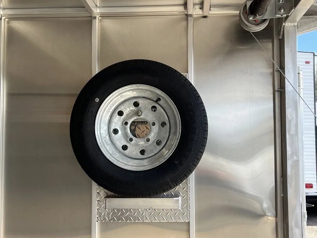 2023 Sno Pro 2-Place Snowmobile Trailer – Galvanized Package – Spare tire mounted vertically on the interior wall of the trailer