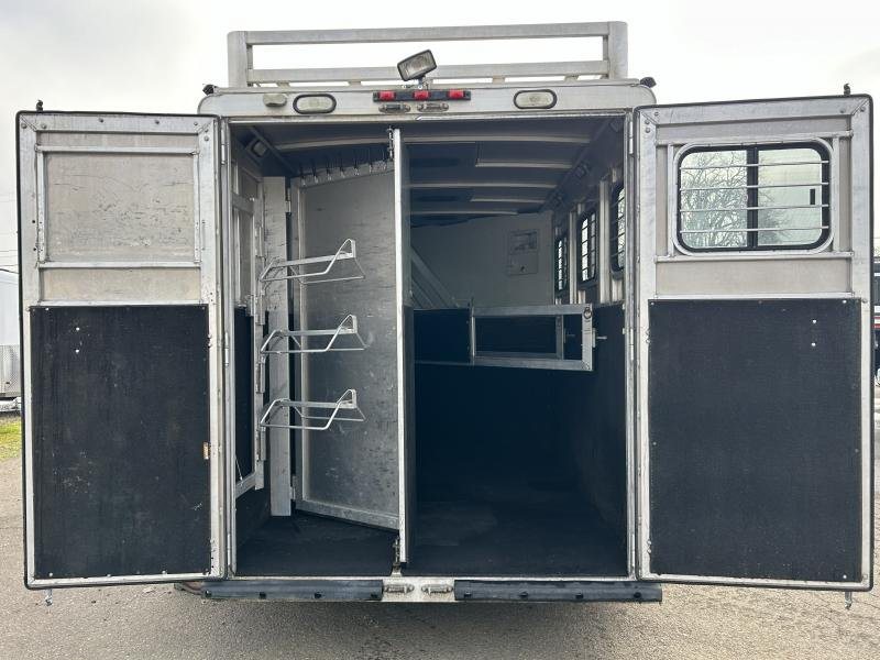 2002 Silverado 3 Horse Gooseneck Trailer – Wood Interior – Rear view of the trailer with doors fully open showing the tack storage area