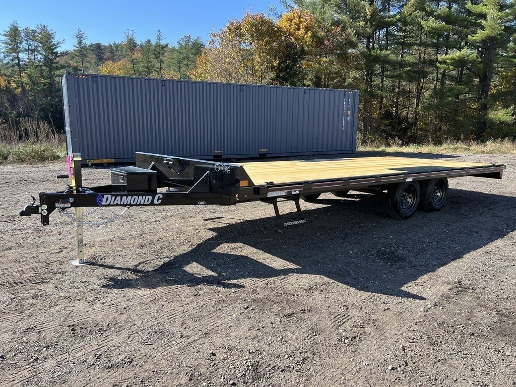 2024 Diamond C 20 ft Deckover – Slide-In Ramps – A three-quarter front view of a black deckover trailer with a wood floor