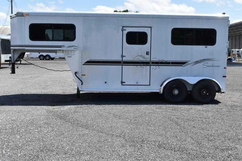 2000 Sundowner 2 Horse Gooseneck Trailer – Dressing Room – Street side exterior view of the horse trailer on gravel
