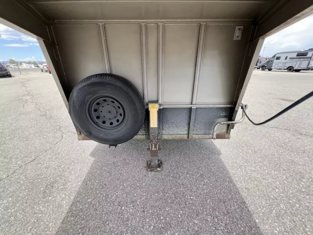 2001 Titan 3 Horse Gooseneck Trailer – Steel, Dressing Room – Close-up of the gooseneck hitch area and mounted spare tire