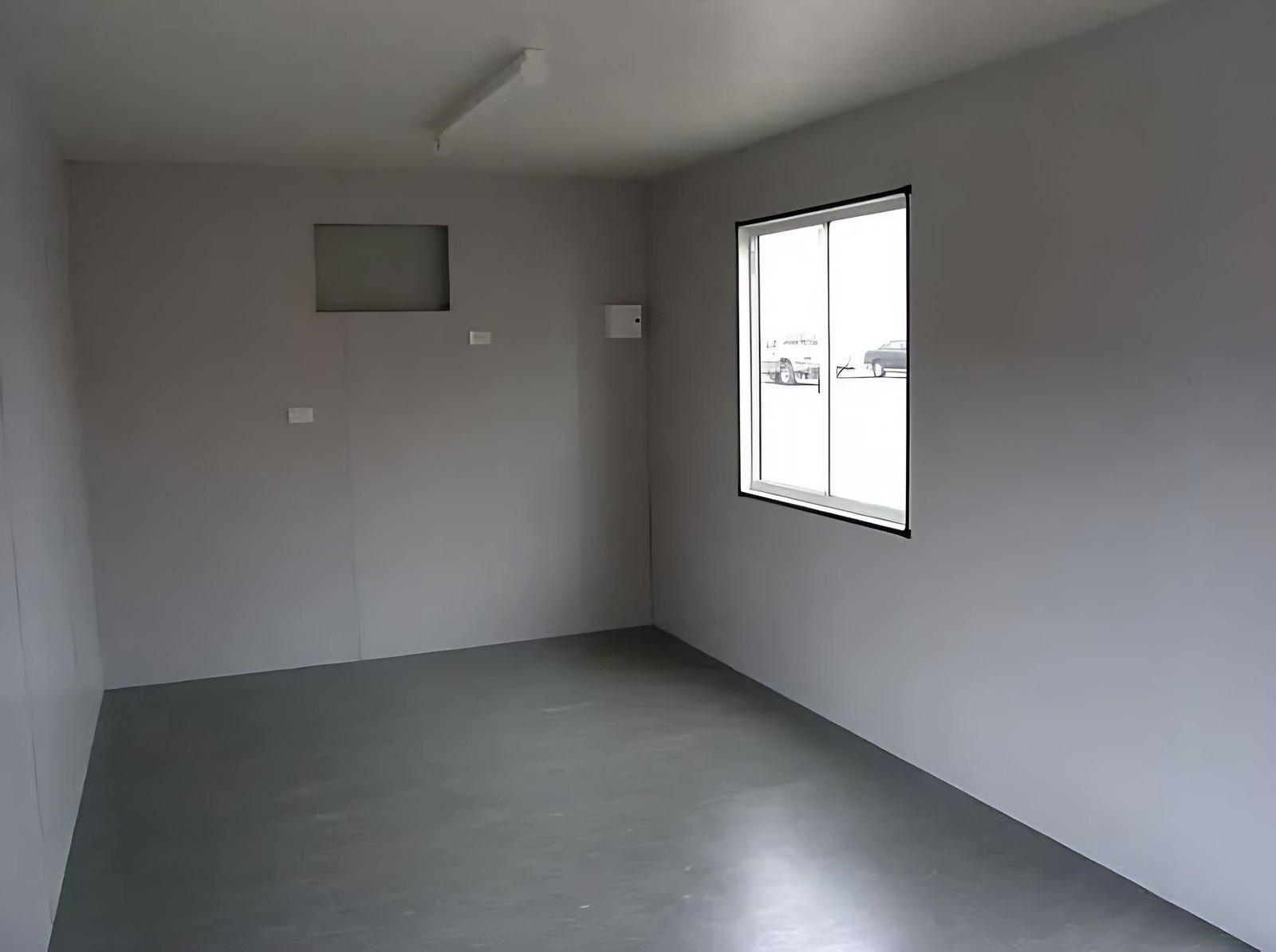 Custom Portable Steel Building – Office, Workshop or Storage – empty room with grey flooring and a sliding window