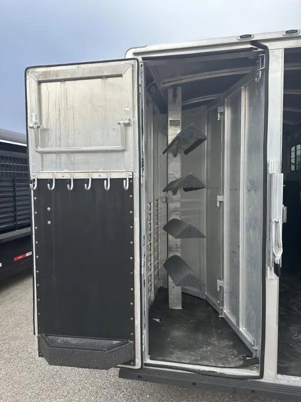 2004 Cherokee Trailers 4-Horse Gooseneck – Rear Tack – Close up of a swing out saddle rack and bridle hooks on the door