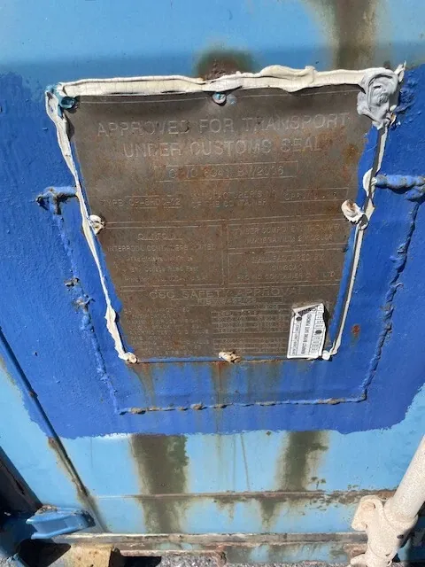 40ft High Cube Shipping Container – Used, Locking Doors – close-up of container safety plate on weathered blue doors
