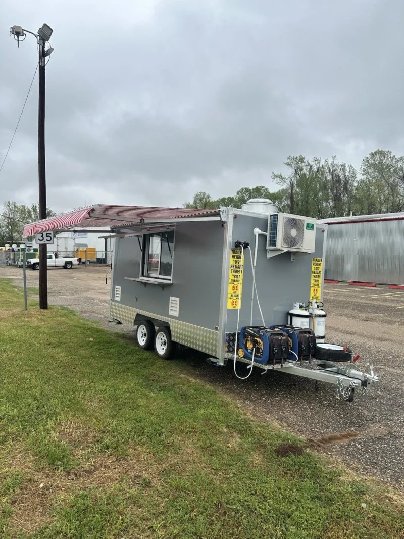 14 ft Food Trailer – Red Finish – Grey food trailer with equipment on the tongue and an awning extended