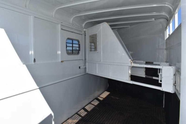 2002 Logan Coach 3 Horse Trailer – Steel, Dressing Room – Interior horse area showing the white padded stall dividers and rubber flooring