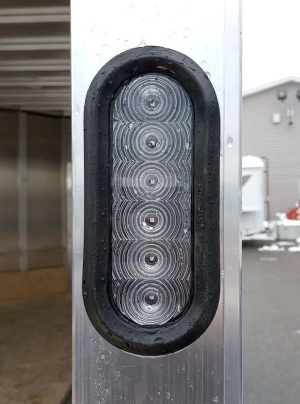 2024 Mission Trailers 12 ft Powersports – Side X Side – Close up of the vertical oval LED tail light mounted on the trailer frame