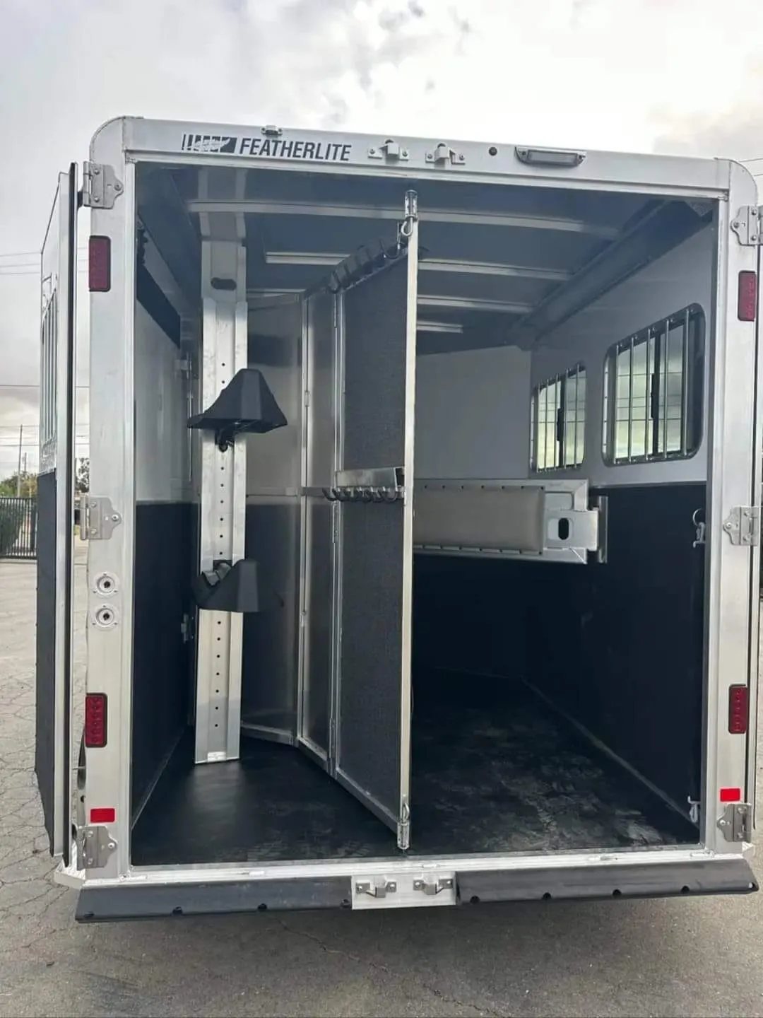 2012 Featherlite 9400 2 Horse Trailer – Removable Tack – Rear view of the trailer with the back doors open revealing the interior