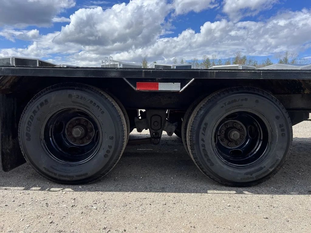 2022 Iron Bull Trailers Equipment Trailer – Rampage Ramps – Close up view of the dual axles and black wheels under the trailer frame