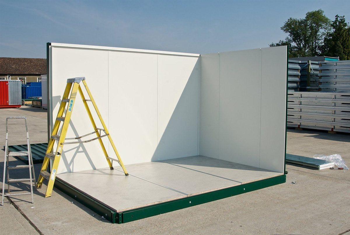 Flat Pack Office – Insulated Panels, Pre-Wired Electrical – partially assembled flat pack office with ladders and exposed floor