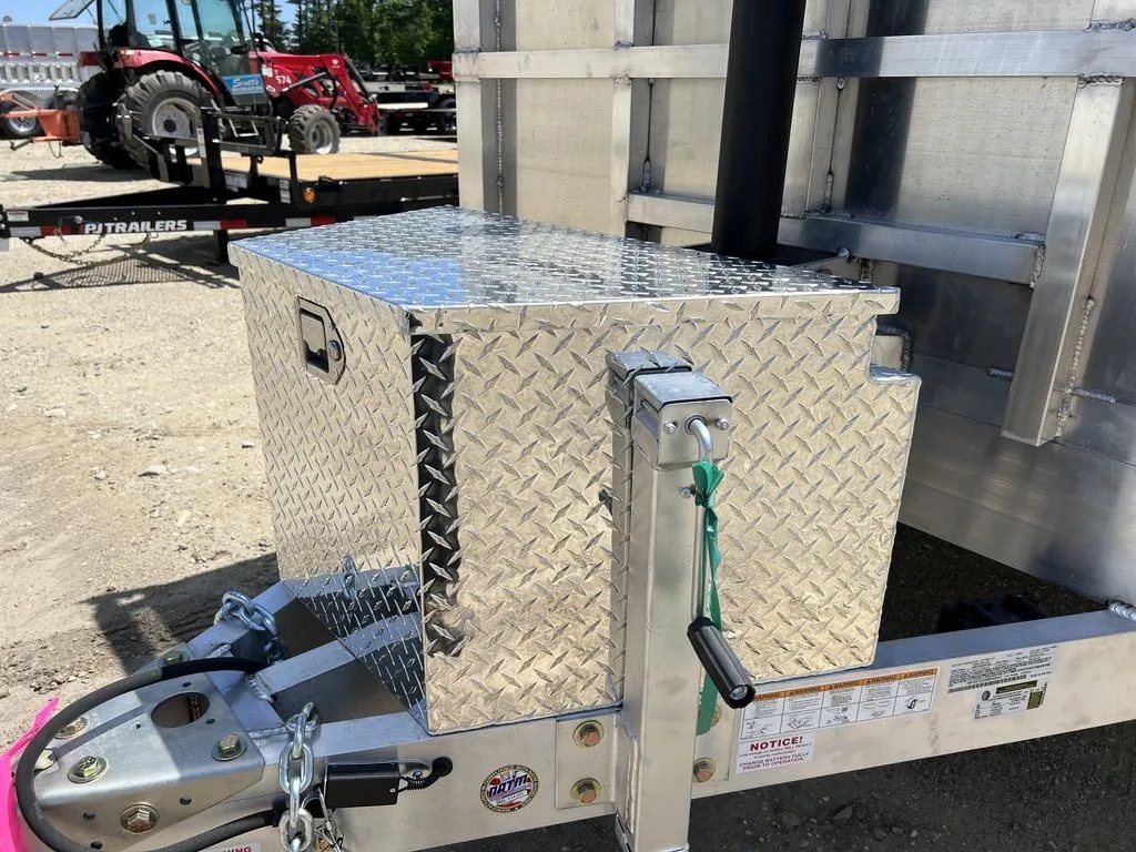 2024 Cargo Pro 12 ft Dump Trailer – Aluminum – Closed diamond plate storage box showing the latch and hydraulic lift cylinder
