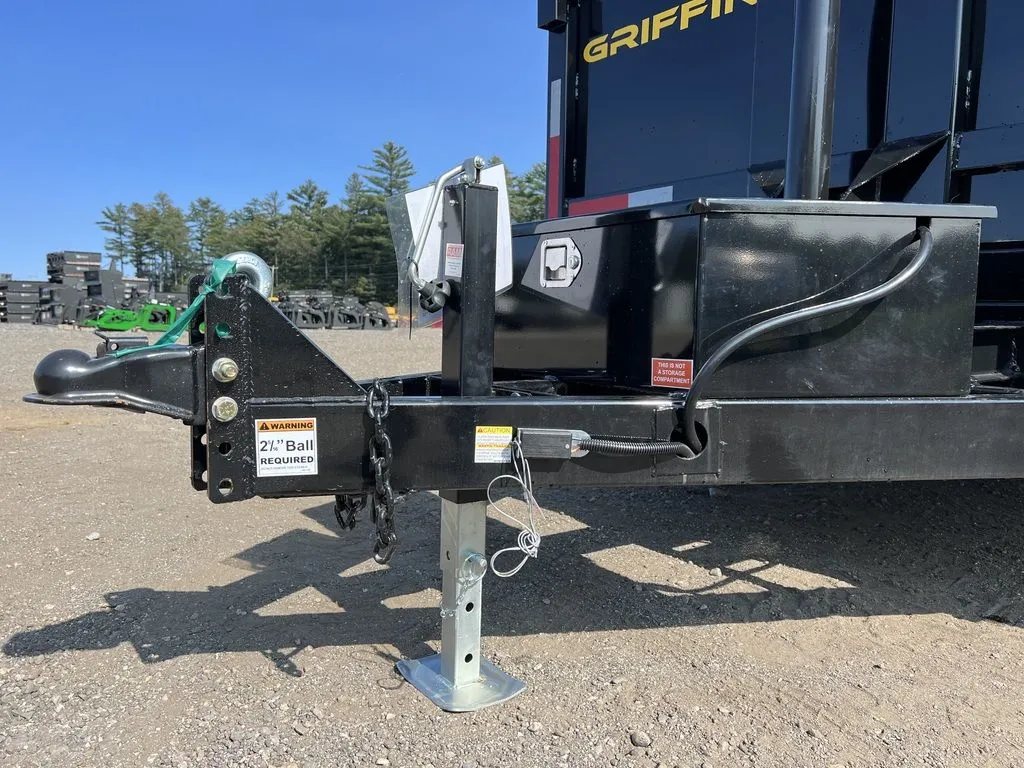 2024 Griffin Trailers 16 ft Dump Trailer – Telescopic – A close-up of the trailer hitch, coupler, and jack assembly