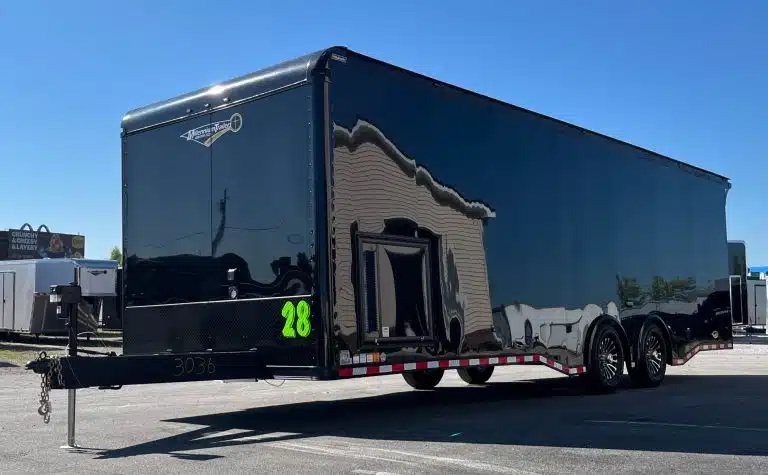 2025 Haulmark Edge 28 ft Car Trailer – Blackout, Turbo – Exterior three-quarter view of black enclosed trailer showing curb side and front