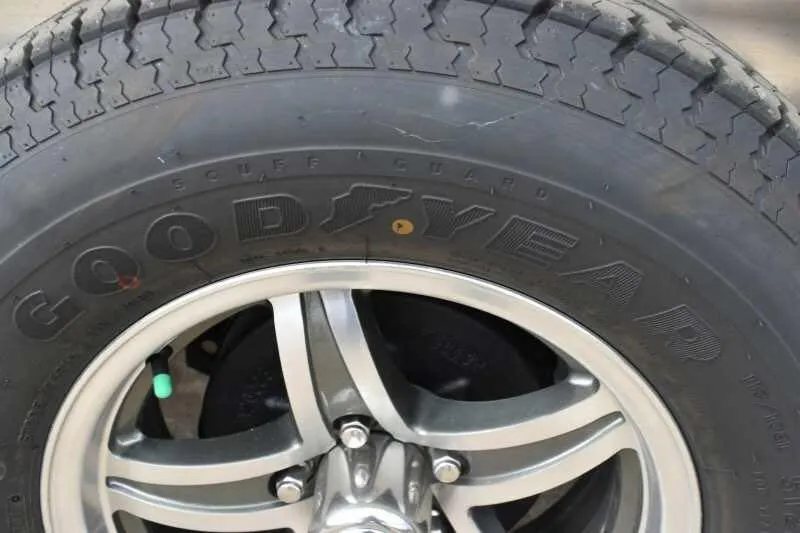 2018 Lakota 2HBPST 2 Horse Trailer – Dressing Room – Close-up of a silver wheel and tire showing the brand name