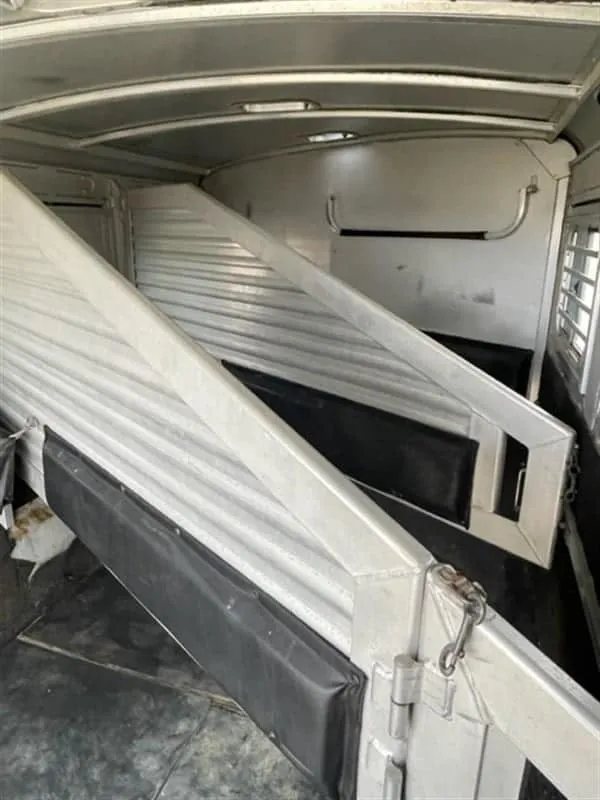 1999 Elite Custom 3 Horse Trailer – Rotating Saddle Rack – Close-up of the aluminum stall dividers inside the horse trailer area