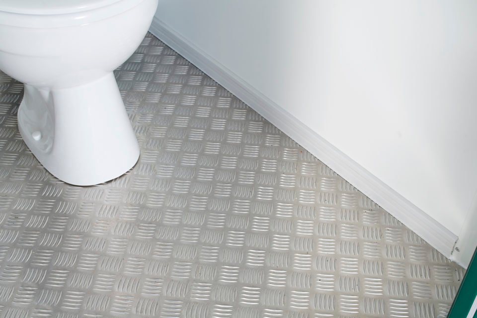 Double Mains Toilet – Green, Two Toilets – Close-up of the anti-slip checker plate flooring inside the toilet unit