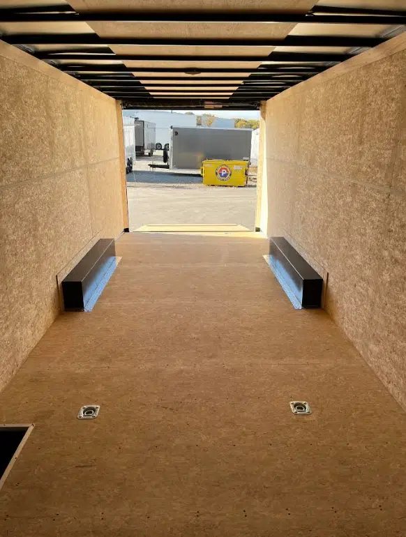 2026 Millennium 24 ft Car Hauler – White Hero – Interior view looking out through the open rear ramp door of the trailer