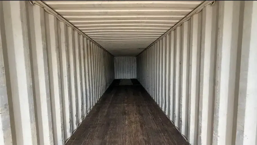 40ft High Cube Shipping Container – Used, Wind & Watertight – empty container interior with corrugated walls and worn wooden floor